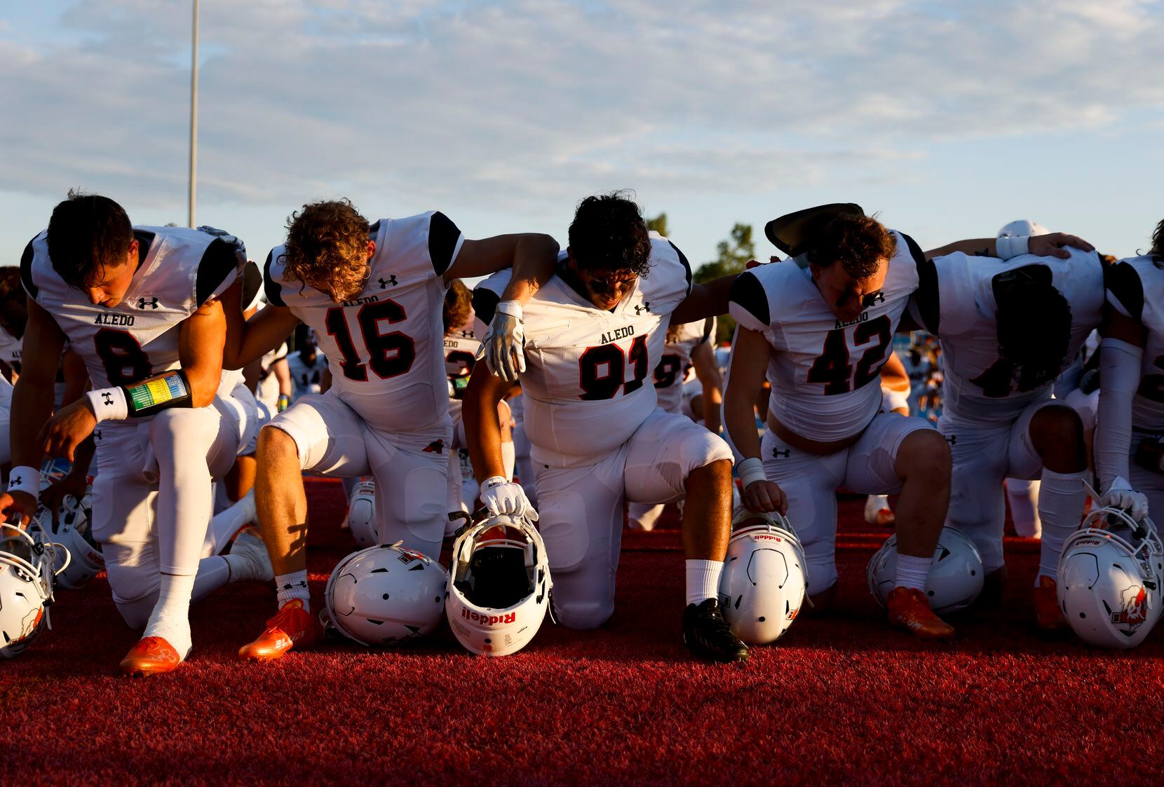 Aledo High players pray ahead of a season-opening football game against Parish Episcopal at...