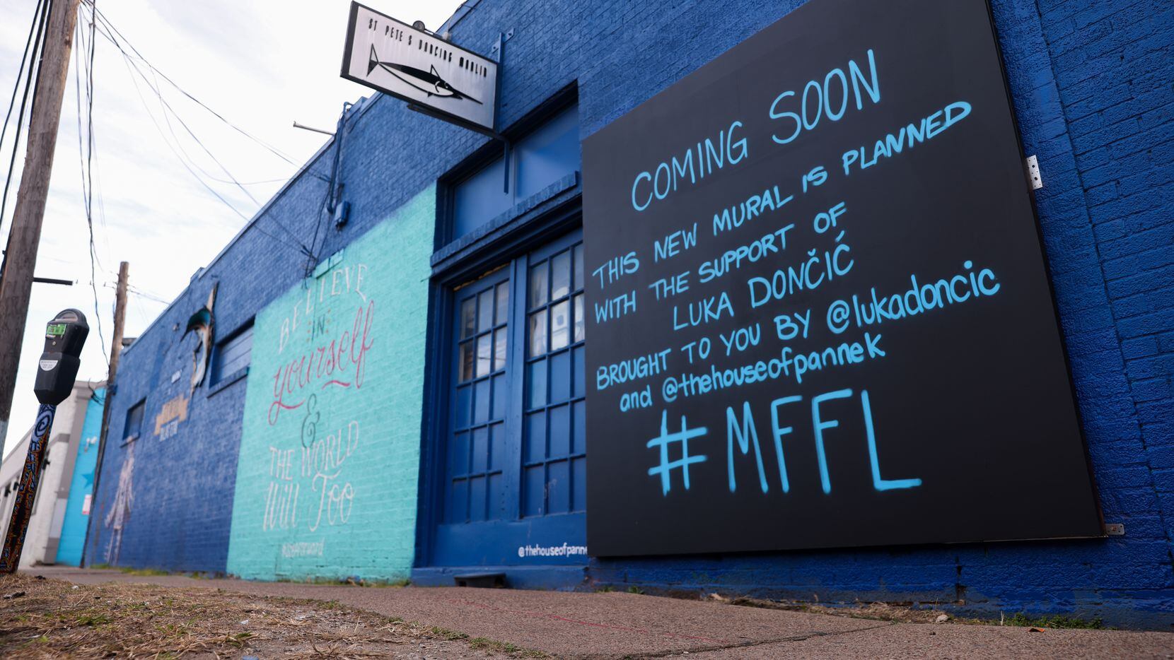 A sign teases a new mural on Tuesday, Jan. 17, 2023, in the spot where Dallas Mavericks Luka...