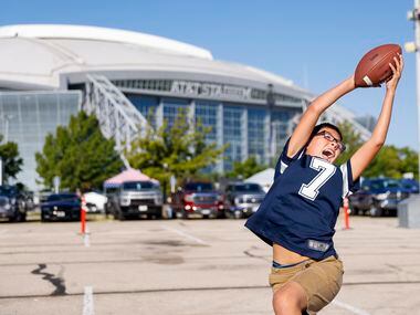 Caleb Malik, 10, plays catch before the Washington Commanders at Dallas Cowboys game on...