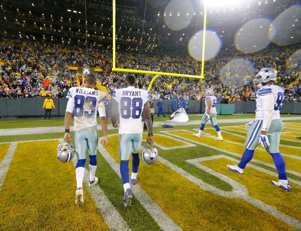 Dallas Cowboys Terrance Williams (83), Dez Bryant (88) and David Irving (95) walk off the...
