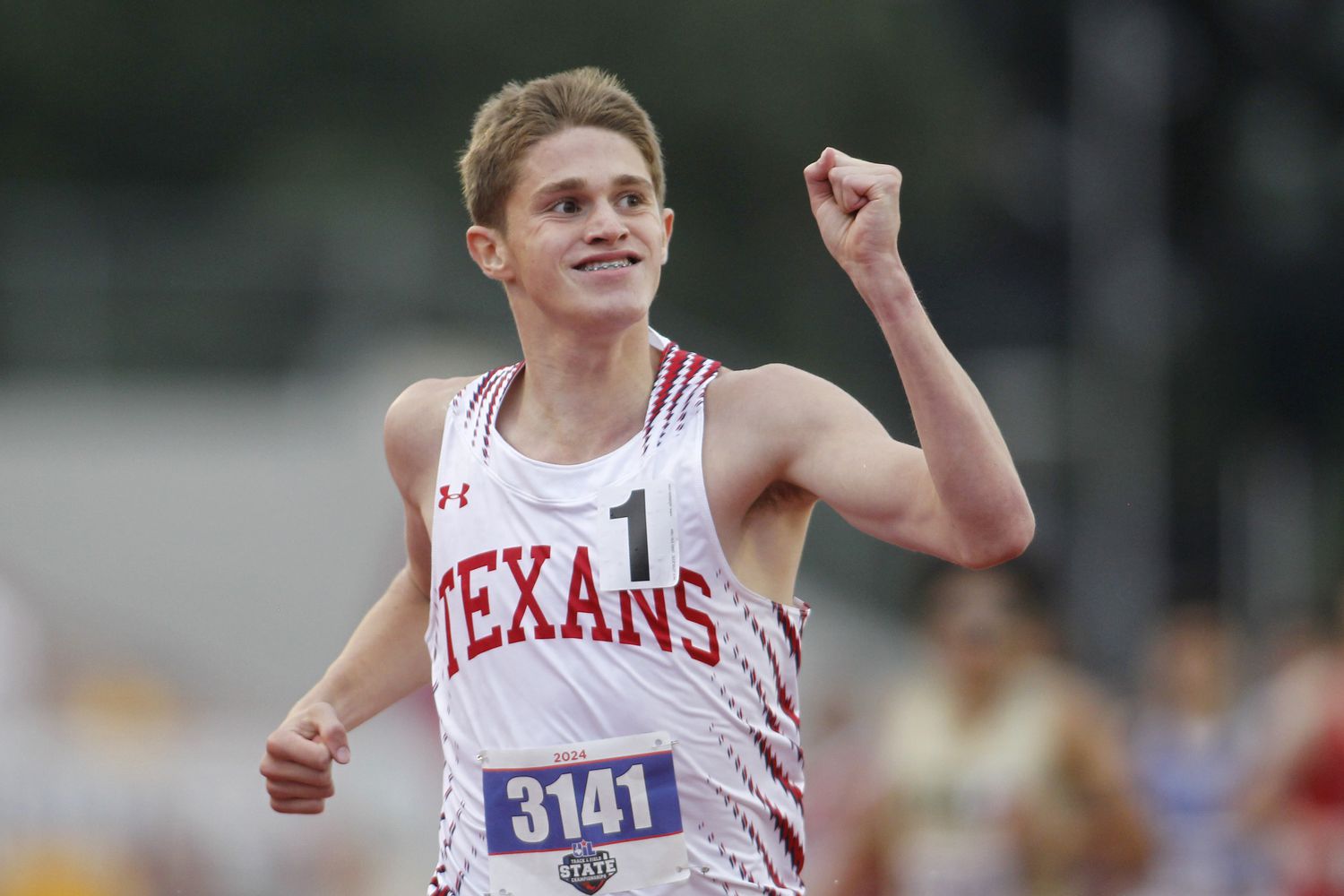 Justin Northwest freshman Cooper Lutkenhaus pumps his fist as he sees his winning time of...
