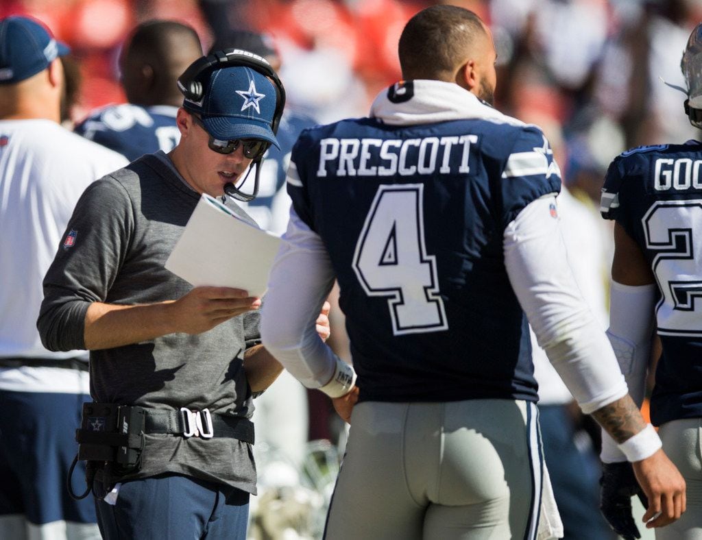 Dallas Cowboys offensive coordinator Kellen Moore (left) talks with Dallas Cowboys quarterback Dak Prescott (4) on the sideline during the fourth quarter of an NFL game between the Dallas Cowboys and the Washington Redskins on Sunday, September 15, 2019 at FedExField in Landover, Maryland.