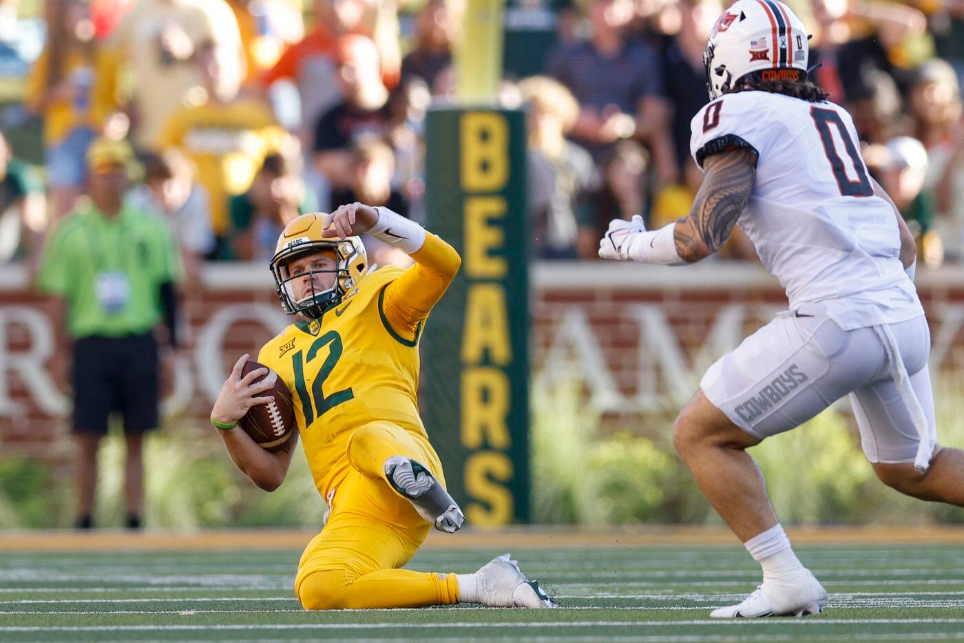 Baylor quarterback Blake Shapen (12) slides short of a first down ahead of Oklahoma State...