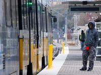 People wait to board a DART train at the Baylor University Medical Center Station in Dallas,...