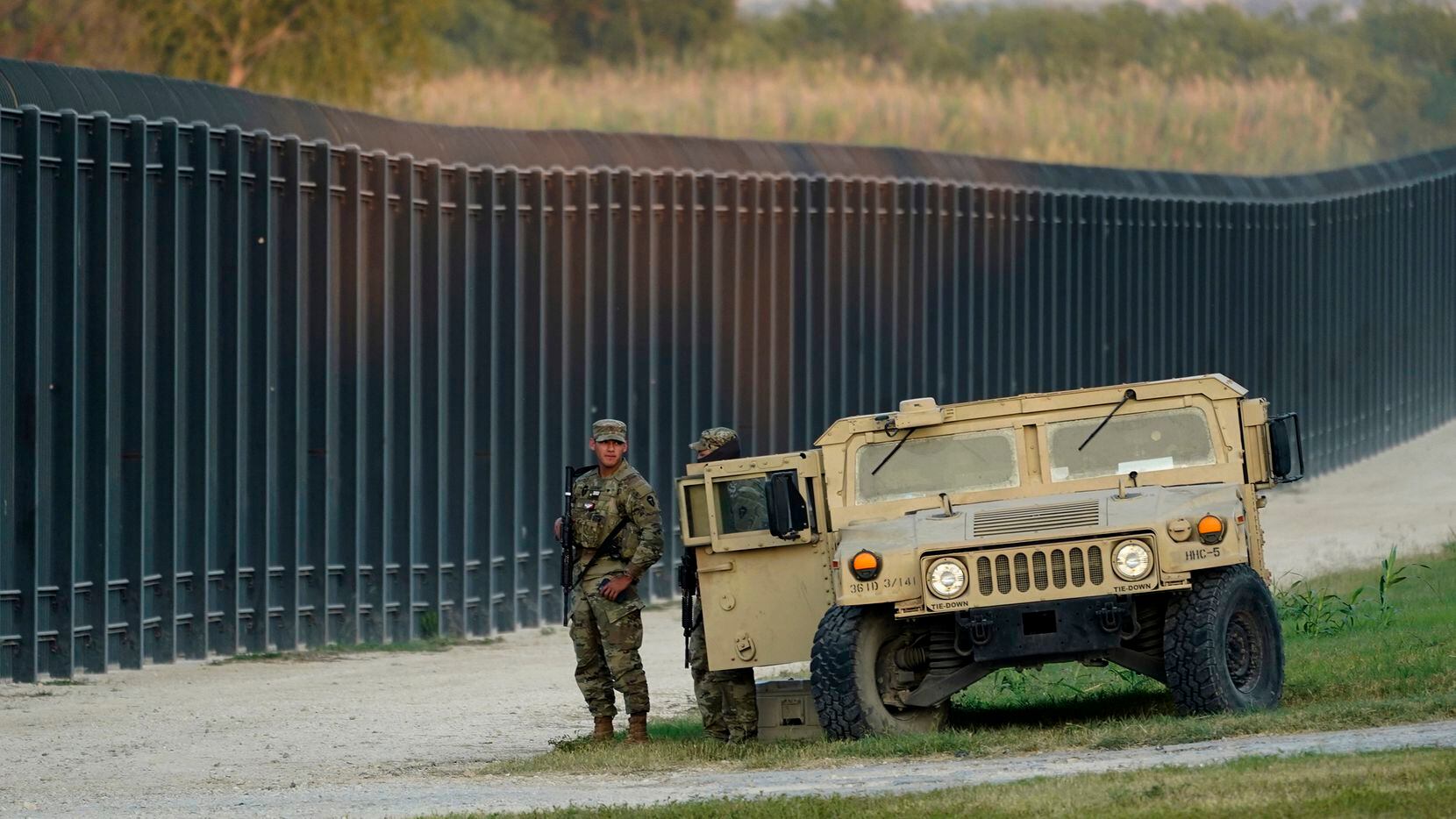 National Guardsmen stand watch over a fence near the International bridge on Sept. 18, 2021,...