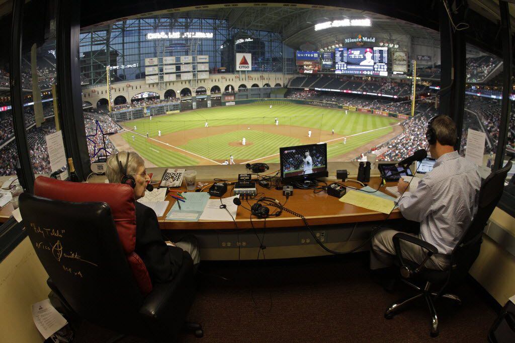 Milo Hamilton, left, and Dave Raymond, right, in the radio booth as Milo calls the Houston...