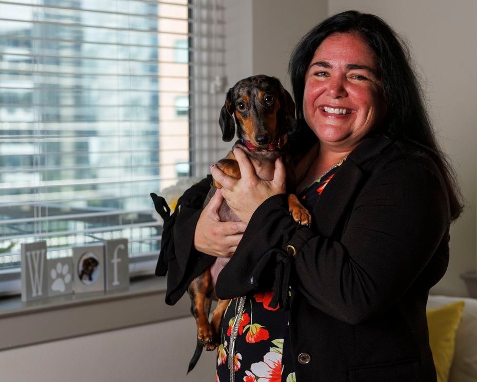 Alison Roche pictured with her dog Winston at her apartment in Uptown Dallas.