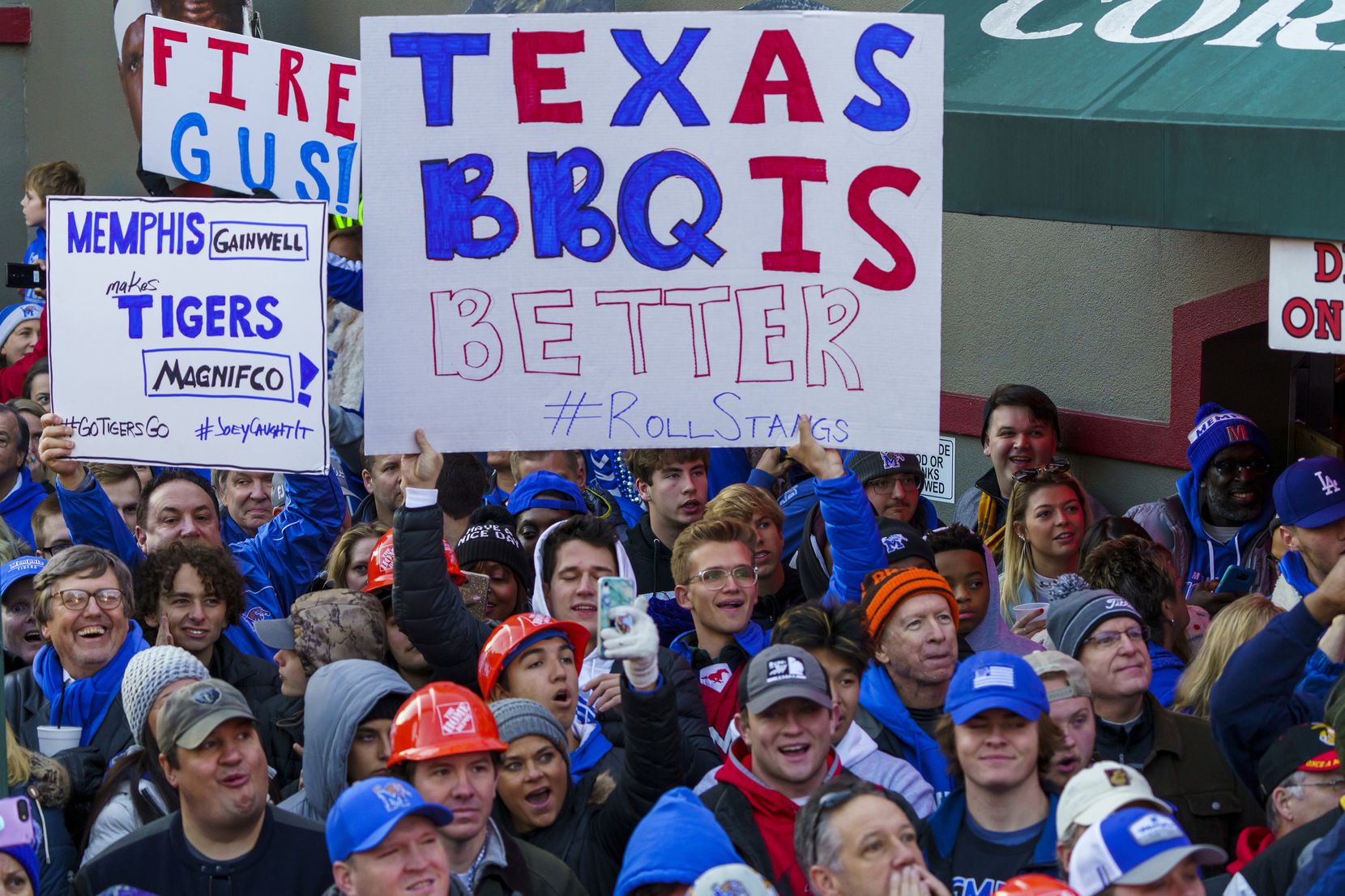 A sign proclaims the superiority of Texas BBQ as SMU fans join the crowd for  ESPN College...