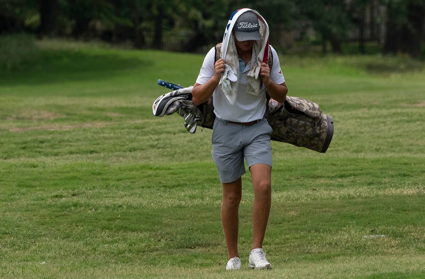 Richardson Pearce, Preston Stout, slowly walks up to his drive on the 18th hole during the...