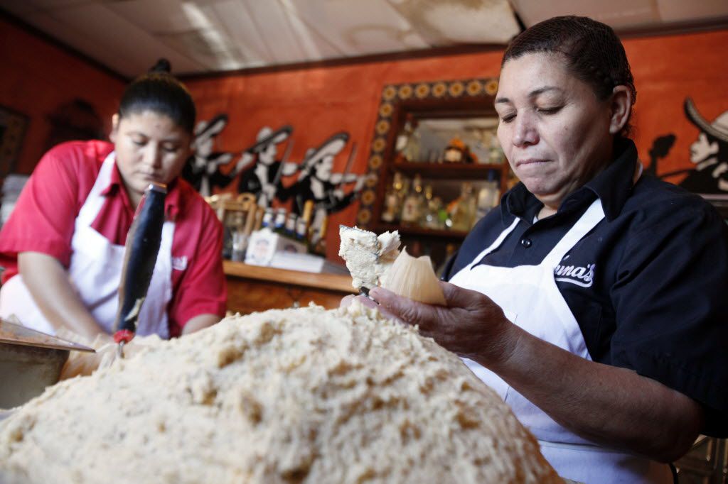 Maria Milan, left, 38, and Armandina Flores, 47, prepare pork with jalapeño tamales to sell...