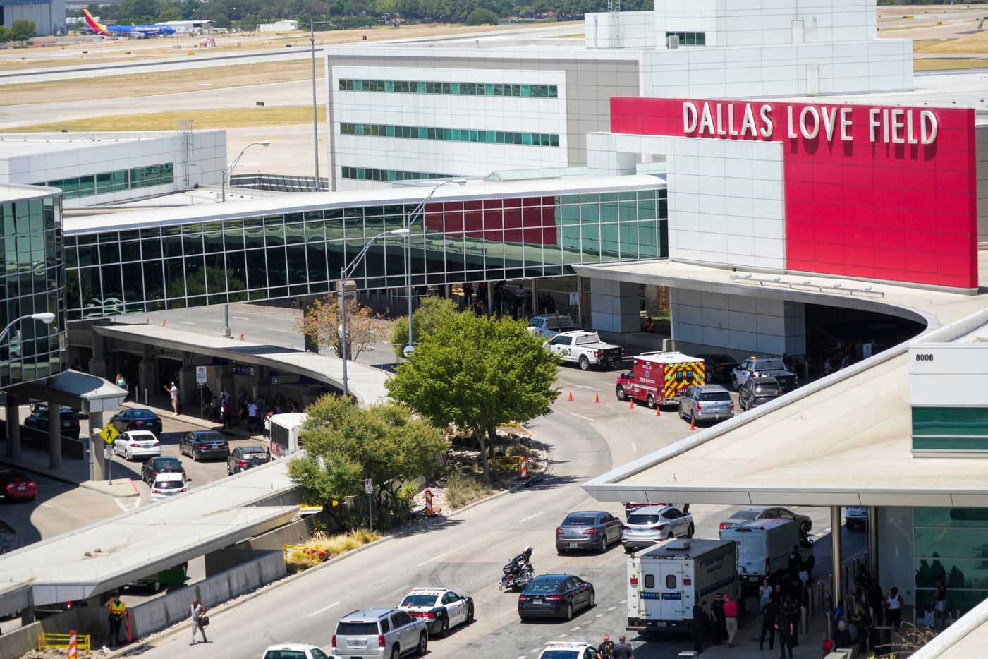 Dallas police work a shooting scene at Dallas Love Field Airport on Monday, July 25, 2022. ...