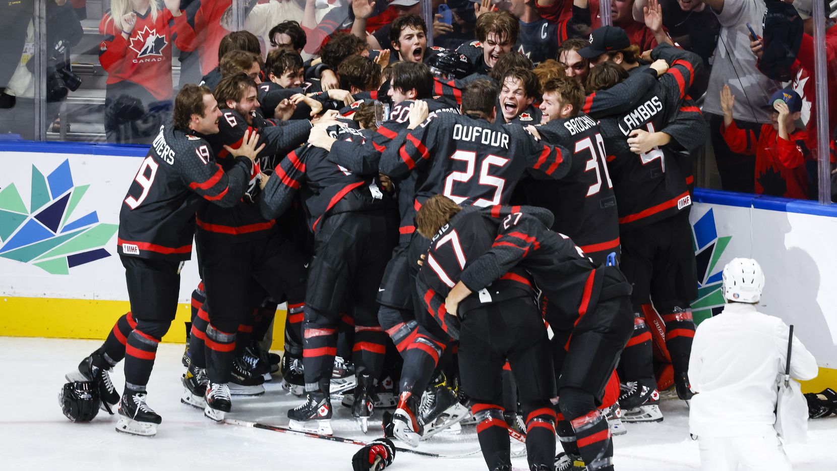 Canada celebrates defeating Finland during overtime in the gold medal game at the world...