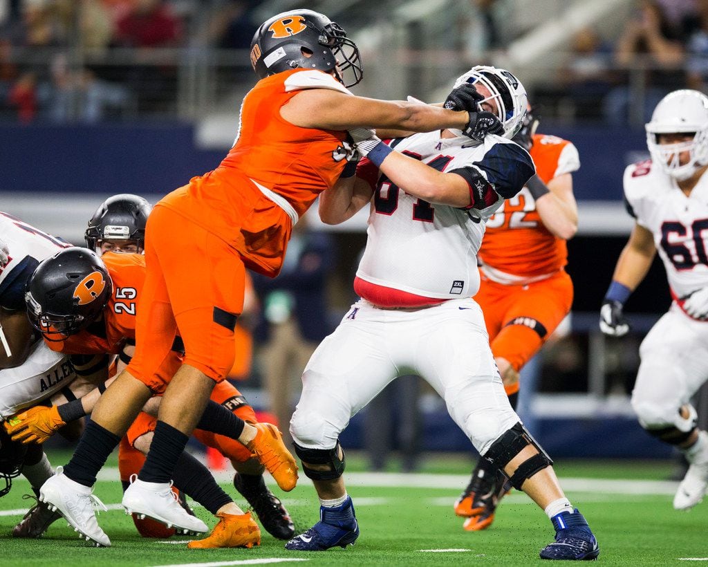 Rockwall defensive tackle Sebastian Hinojosa (95) gets ahold of Allen offensive lineman Kolton Ehlert (64) during the first quarter of a Class 6A Division I area-round high school football playoff game between Allen and Rockwall on Friday, November 22, 2019 at AT&T Stadium in Arlington. (Ashley Landis/The Dallas Morning News)