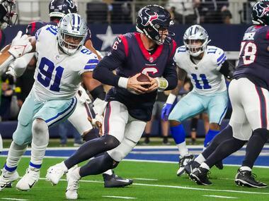 Houston Texans quarterback Jeff Driskel (6) scrambles away from Dallas Cowboys defensive end...