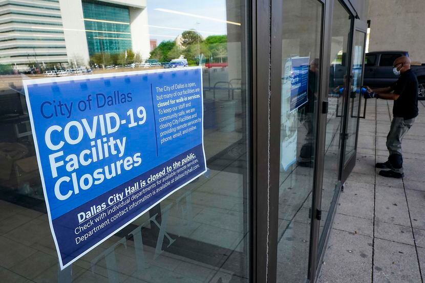 A sign announces the public closure of city facilities at Dallas City Hall on Tuesday, March...