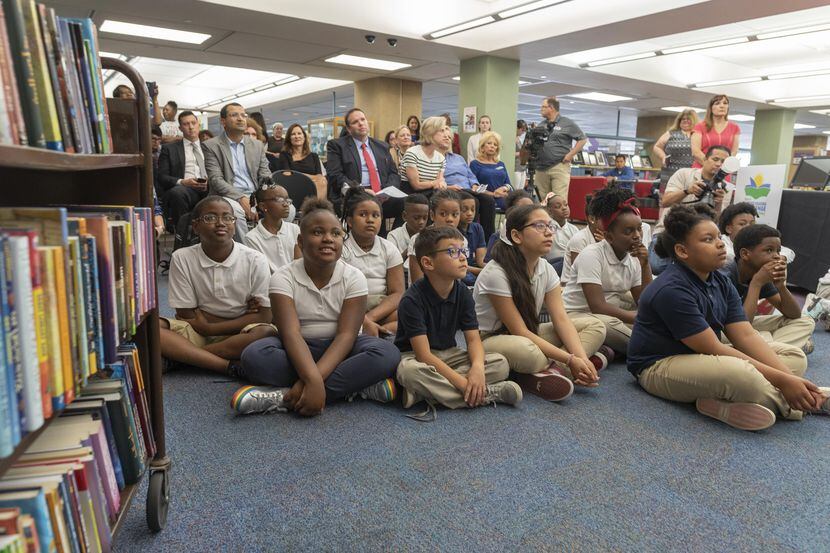 Un grupo de niños escucha al alcalde Mike Rawling presentar el desafío de lectura para el...