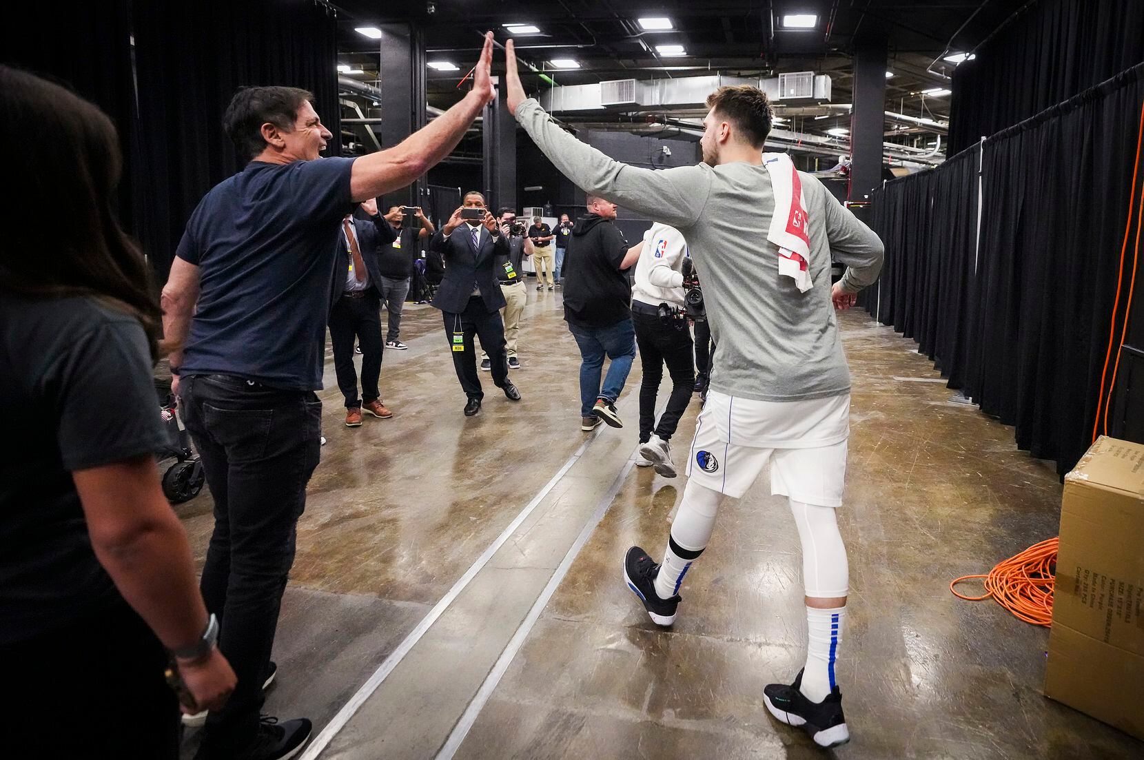 Dallas Mavericks guard Luka Doncic celebrates with team owner Mark Cuban as he leaves the...