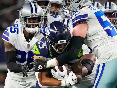 Seattle Seahawks running back Travis Homer (25) is brought down by Dallas Cowboys linebacker...