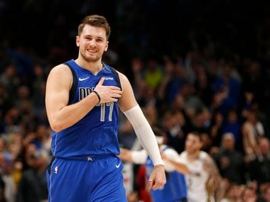 FILE - Mavericks guard Luka Doncic (77) reacts after making a 3-pointer late in overtime against the Pelicans at American Airlines Center in Dallas on Wednesday, March 4, 2020.