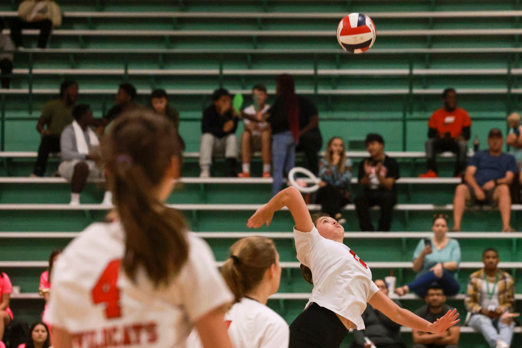Lake Highlands High School Hayden Layne (13) spikes the ball during the volleyball game...