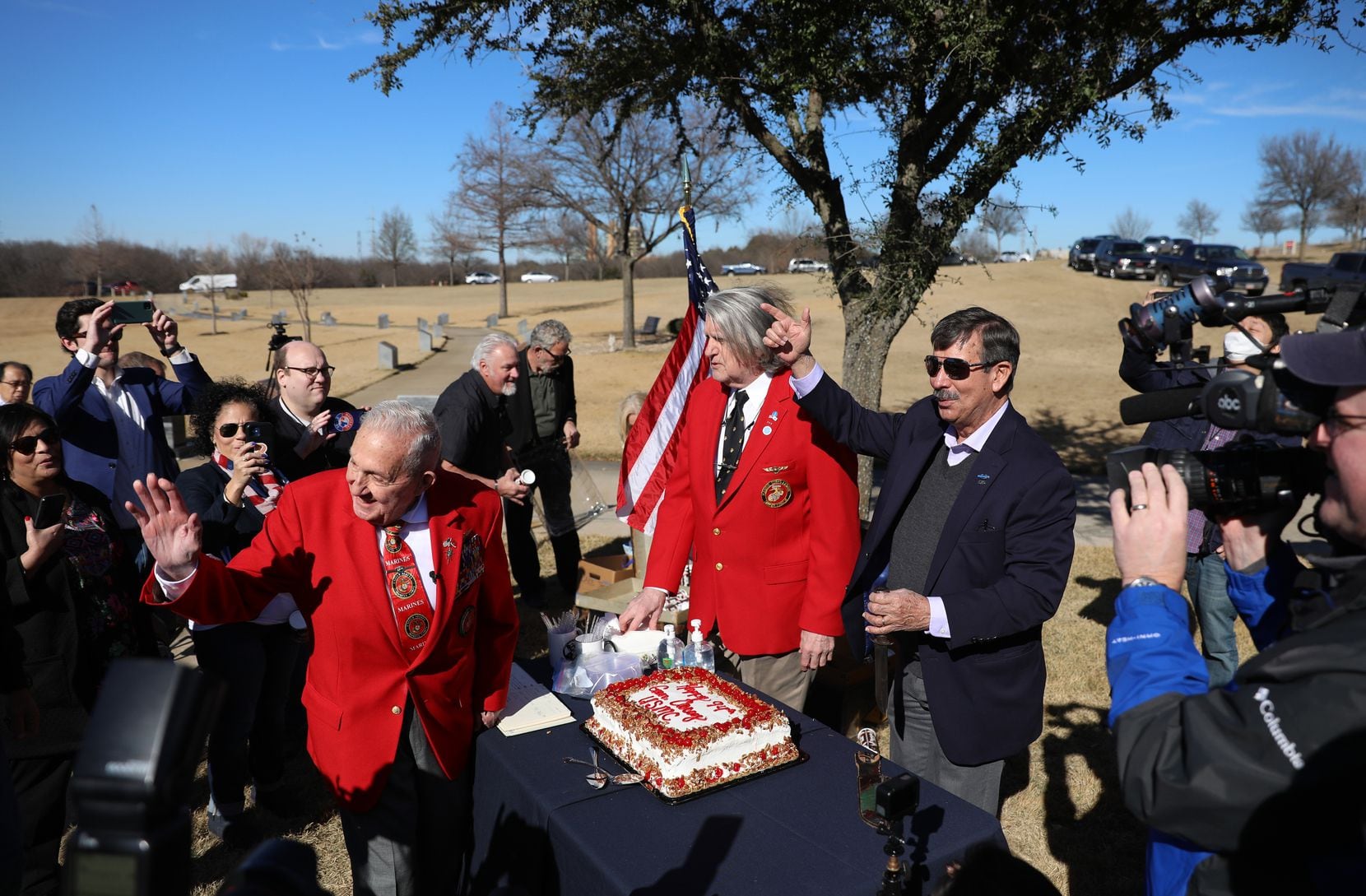 The crowd sings "Happy Birthday" to retired Lt. Gen. Richard Carey (left) at an impromptu birthday 94th birthday celebration after the groundbreaking for the Chosin Few Memorial at Dallas-Fort Worth National Cemetery.