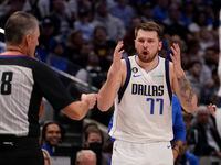 Dallas Mavericks guard Luka Doncic (77) questions a call by referee Scott Foster (48) during...