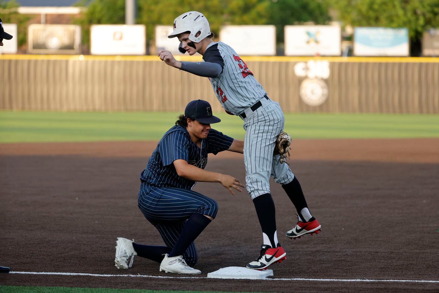 Keller’s Michael Dattalo tags out Flower Mound Marcus player Caden Sorrell at third during...