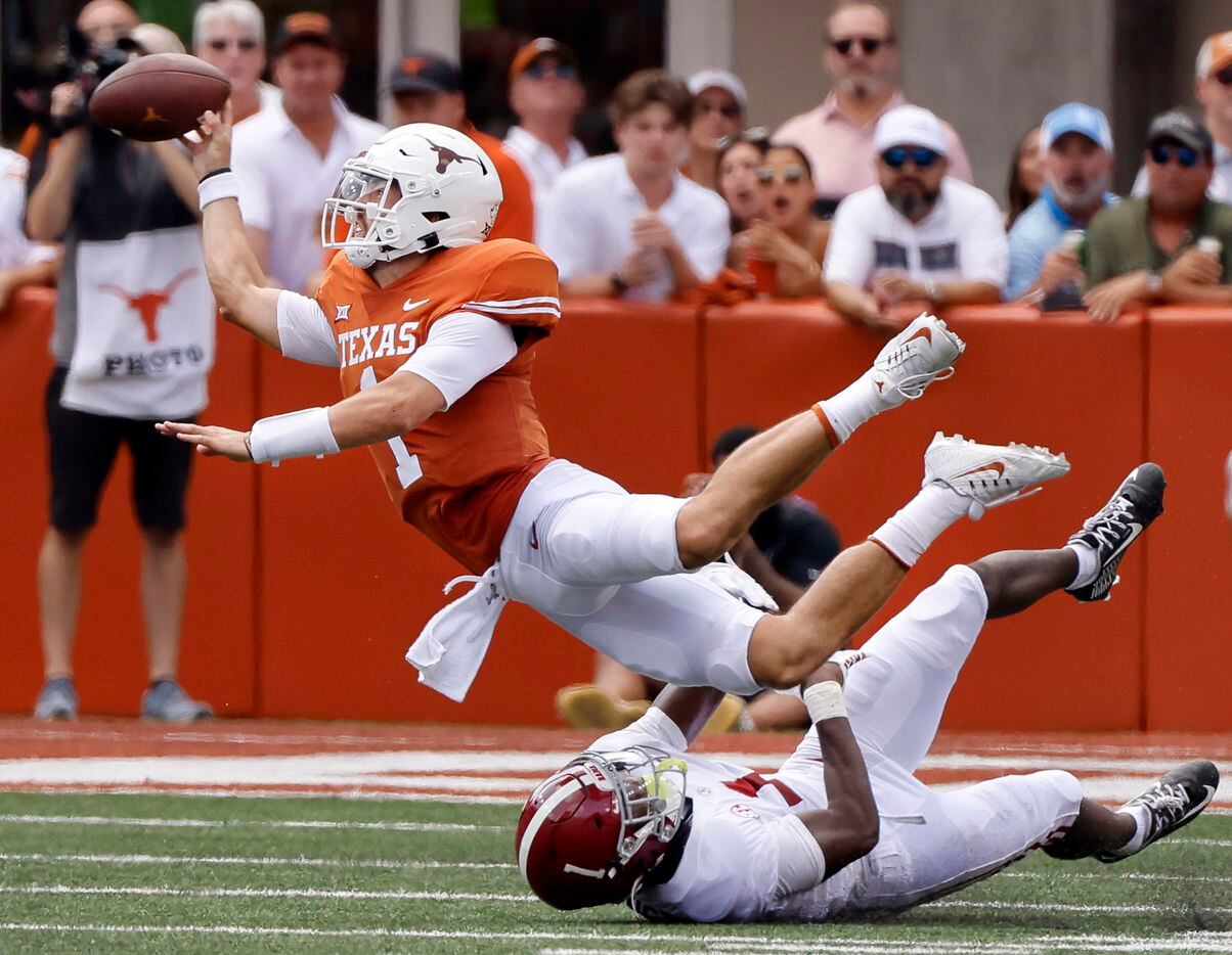 Texas Longhorns quarterback Hudson Card (1) throws the ball away to avoid the sack by...