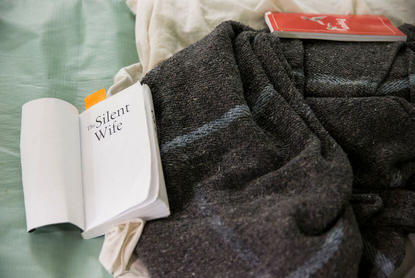 A book called The Silent Wife and a book of prayers lie on a female inmate's bed at the...