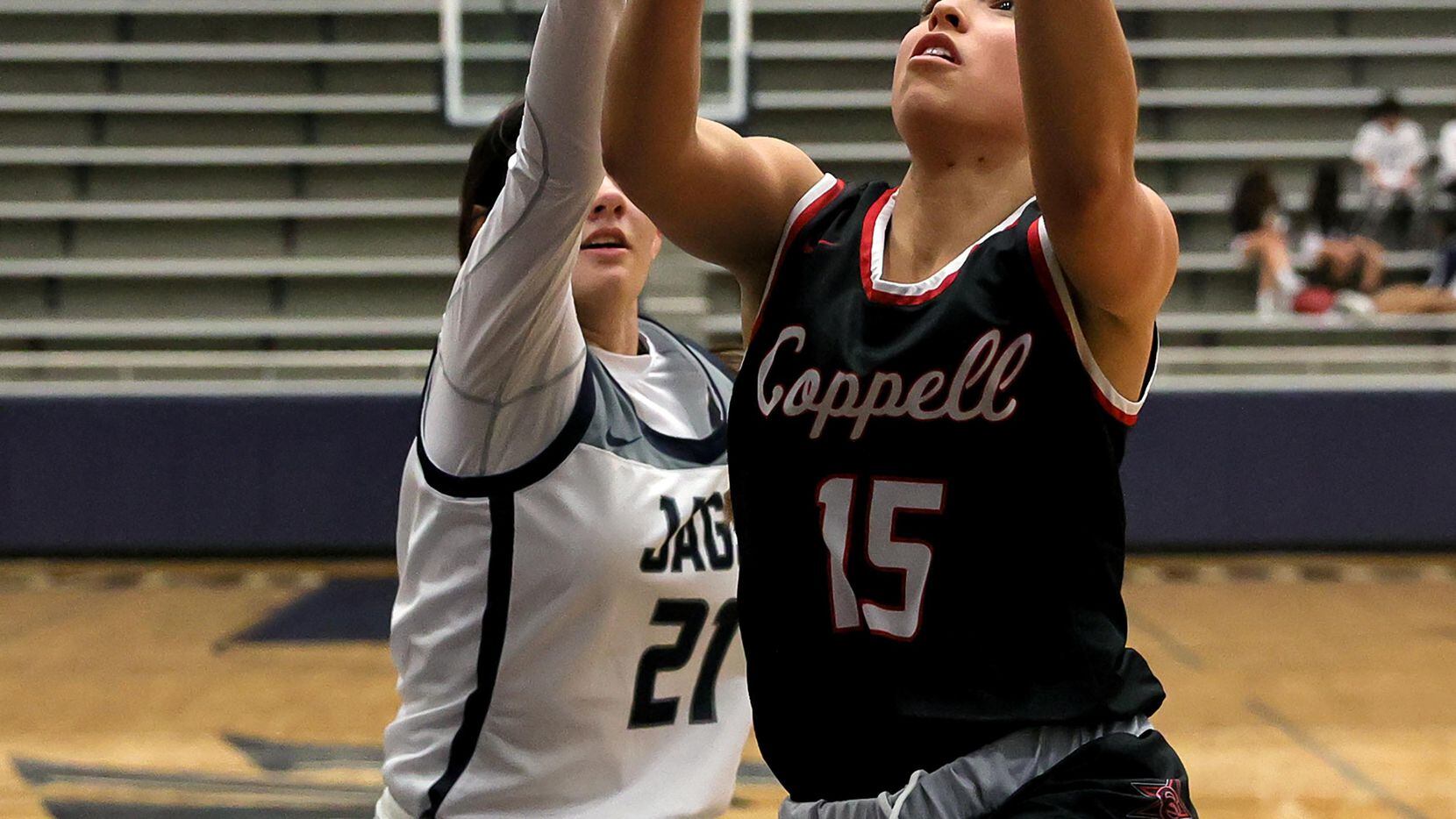 Coppell guard Atia Medenica (15) goes strong to the basket against Flower Mound guard...