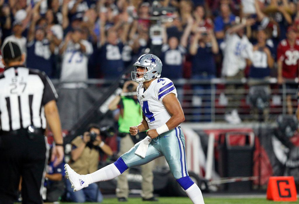 Dallas Cowboys quarterback Dak Prescott (4) celebrates after scoring a touchdown in a game...