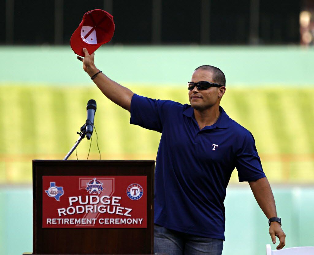 Former Texas Rangers catcher Ivan "Pudge" Rodriguez waves to the crowd during his retirement...