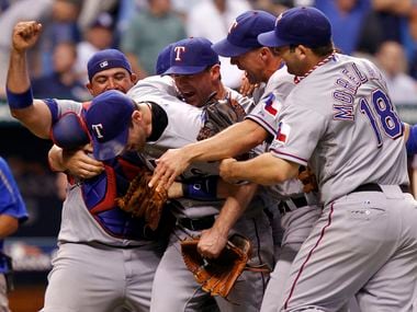 FILE - Rangers players Bengie Molina (11), Cliff Lee (33), Michael Young (10), David Murphy and Mitch Moreland (18) celebrate after beating the Rays in Game 5 of the ALDS at Tropicana Field in St. Petersburg, Fla., on Oct. 12, 2010.