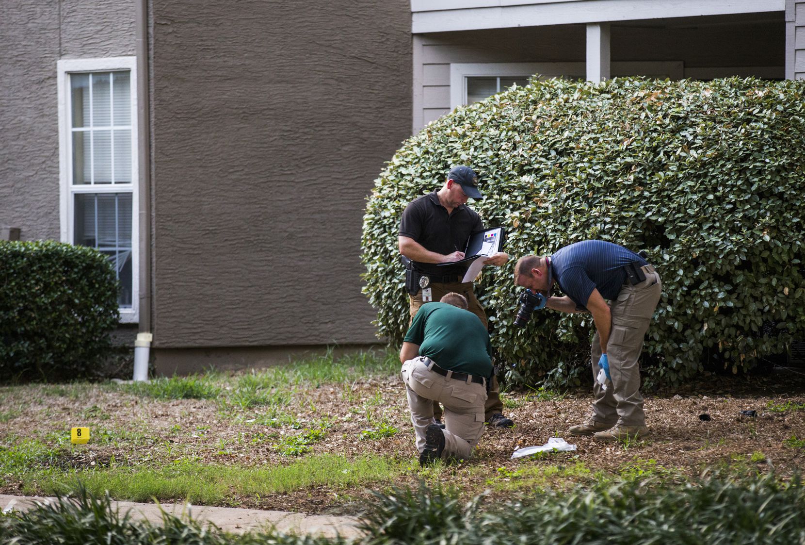 Lewisville police officers investigate a scene where a man fatally stabbed a toddler on...