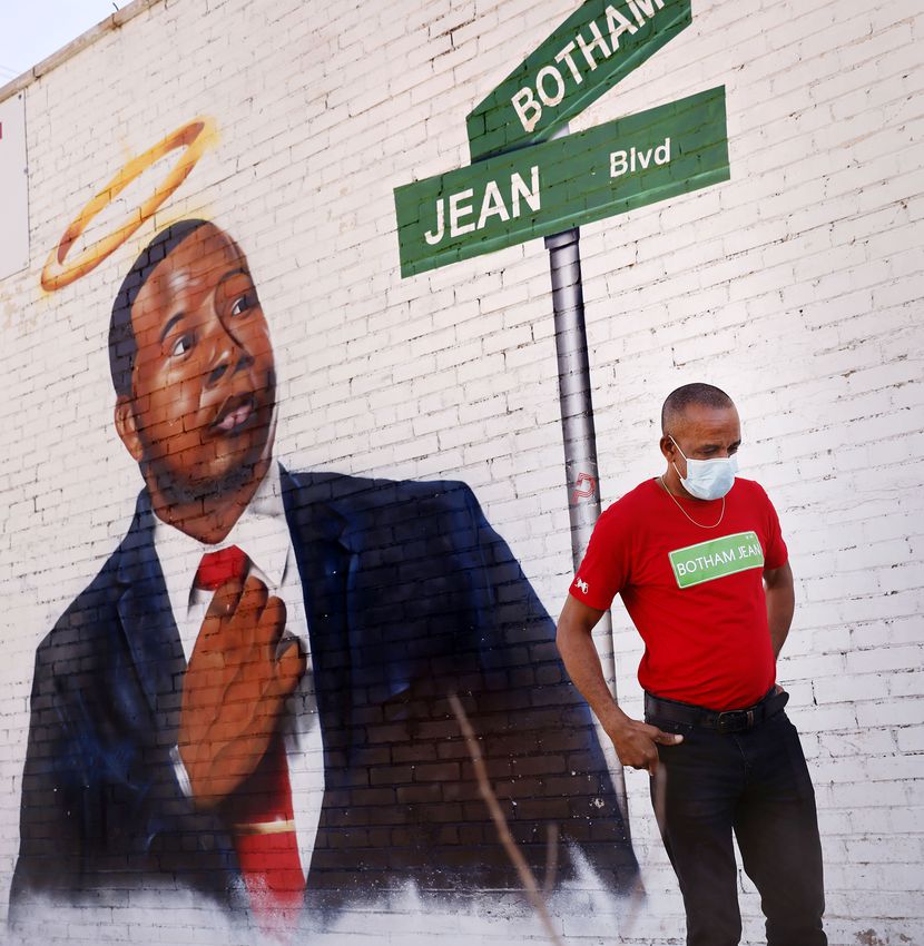 Bertrum Jean takes a moment for himself as he views a mural of his slain son, Botham Jean,...