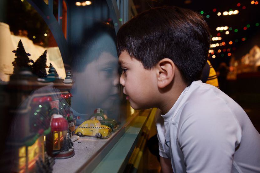 Nathan Reyna, 5, of Dallas, places his nose against glass as he watches the trains roll by...