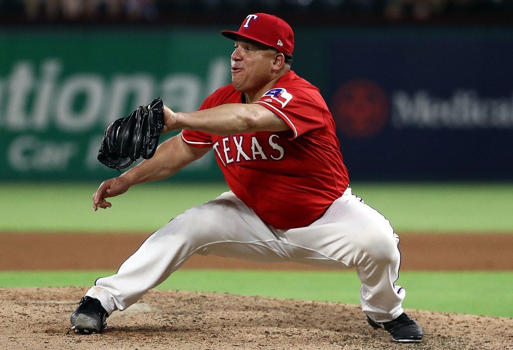 ARLINGTON, TX - AUGUST 07:  Bartolo Colon #40 of the Texas Rangers makes the catch for the...
