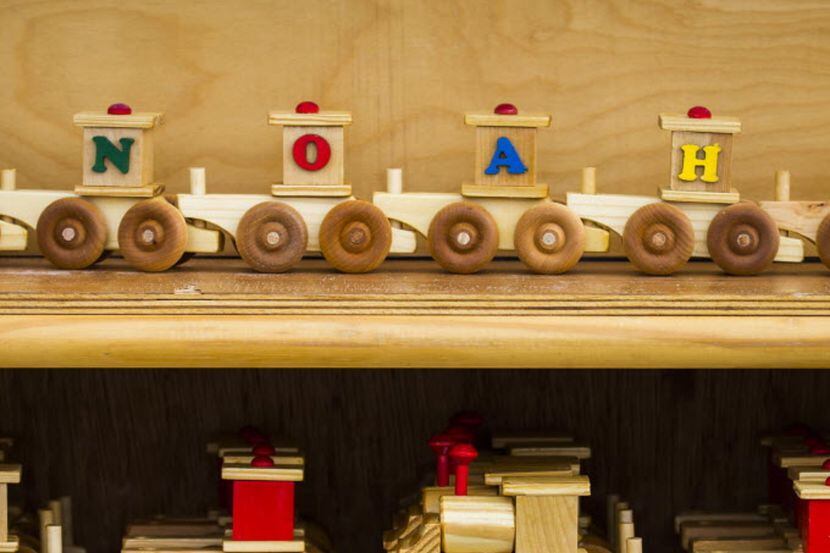 Wooden toy trains for sale at a booth during a previous Good Local Markets holiday event.