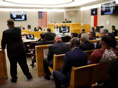 Using a court divider as an example, Assistant District Attorney Jason Hermus (back to...