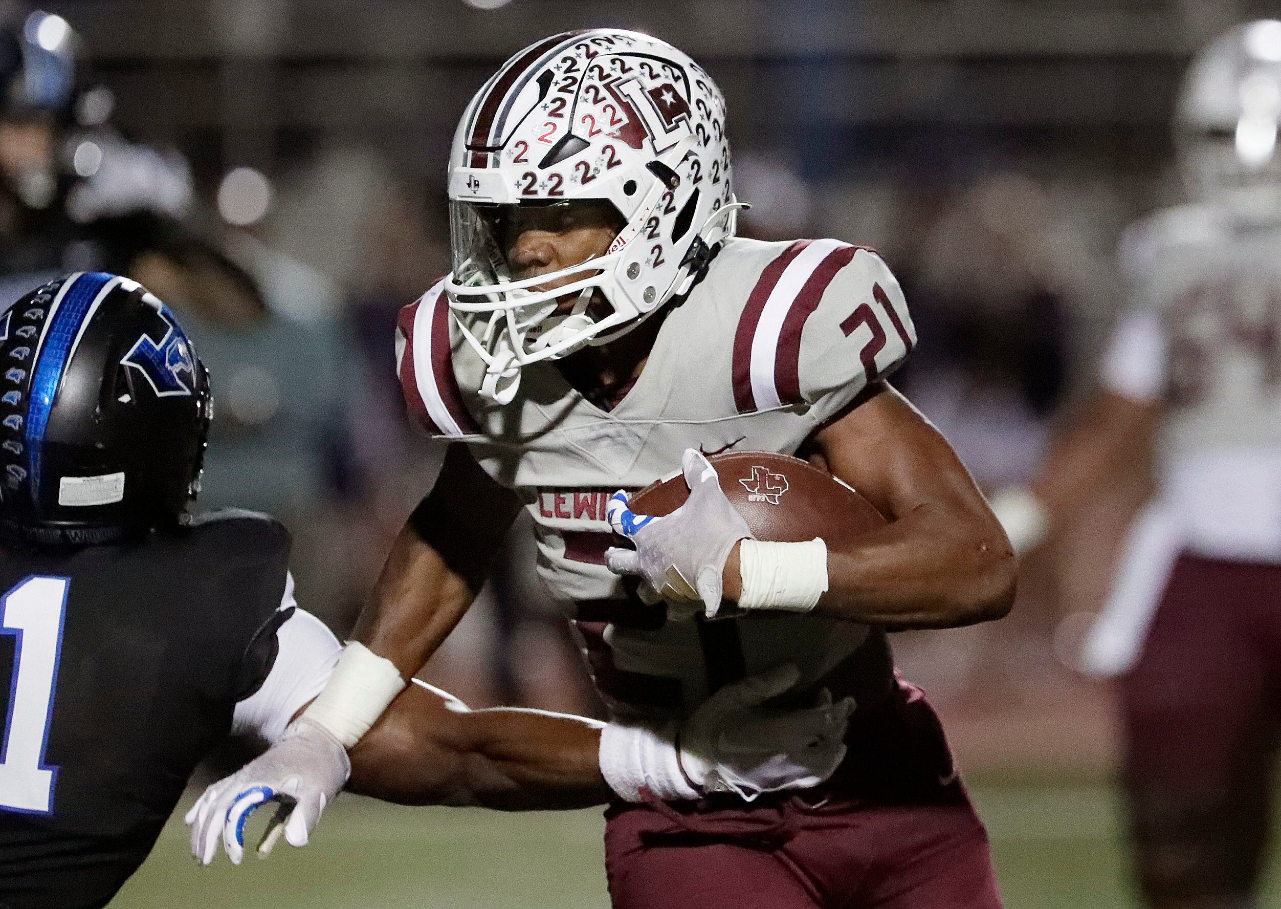 Lewisville High School running back Viron Ellison (21) escapes the arm tackle of Hebron High...