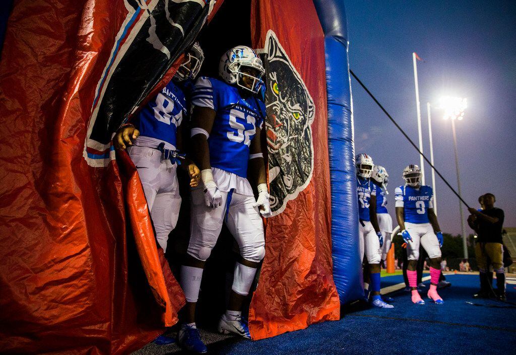 Duncanville football players wait to enter the field before a high school football game...