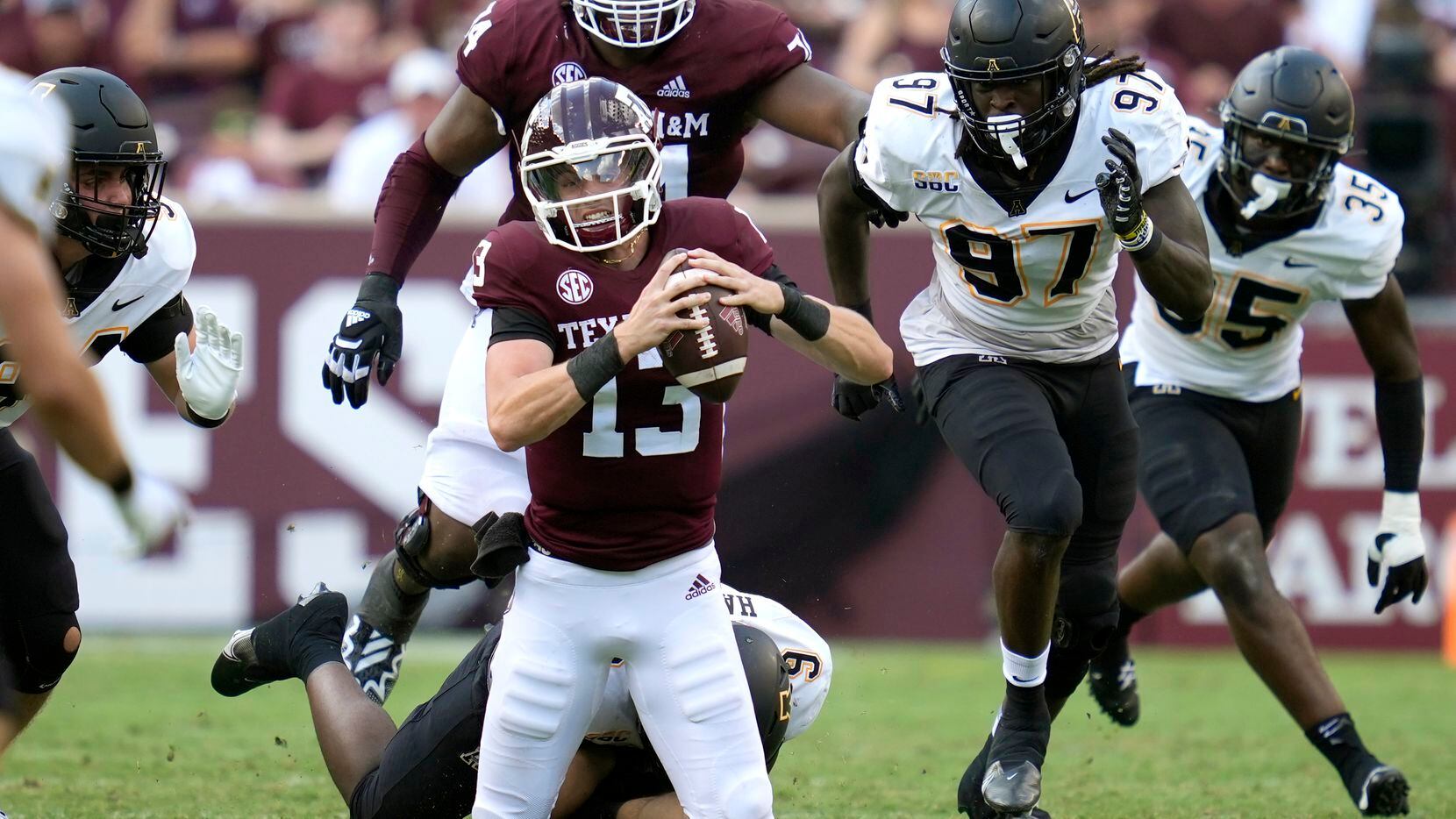 Texas A&M quarterback Haynes King (13) is tackled for no gain by Appalachian State...