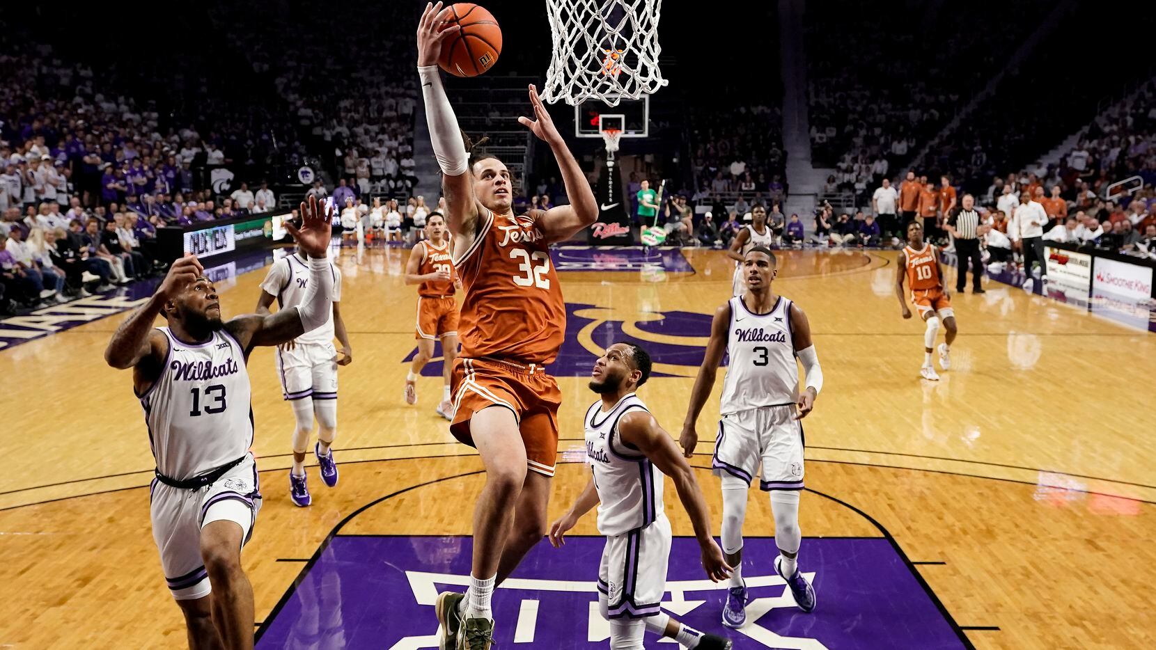 Texas forward Christian Bishop (32) puts up a shot during the first half of an NCAA college...