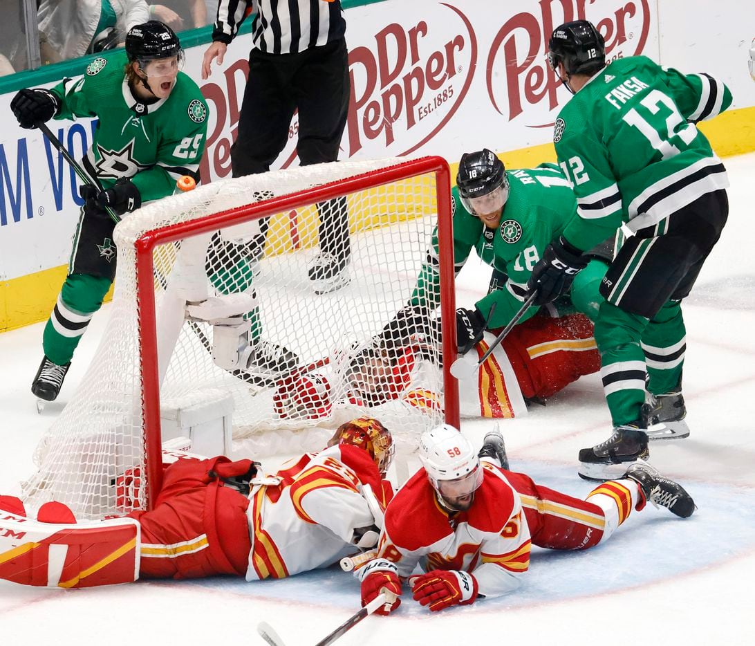 Dallas Stars left wing Michael Raffl (18) stuck the puck past Calgary Flames goaltender...