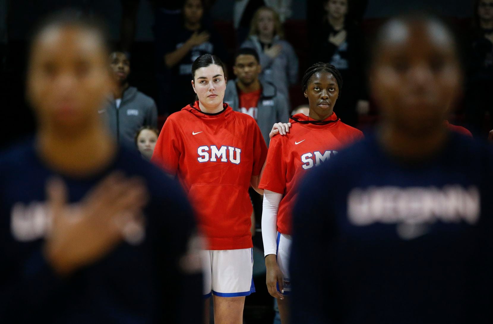 The Southern Methodist Mustangs and UConn Huskies line up for the national anthem prior to a...