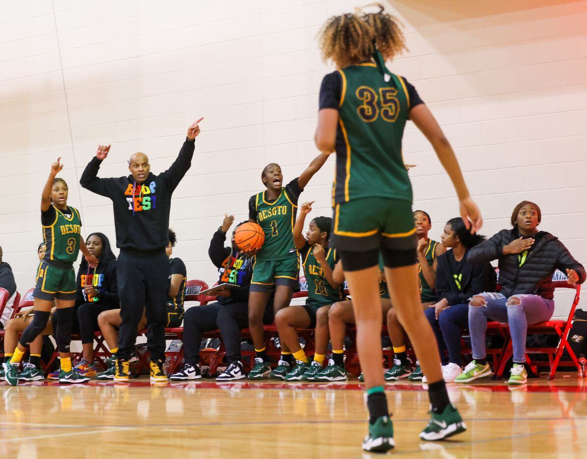 DeSoto girls basketball coaches and players yell for control of an out of bound play in the...