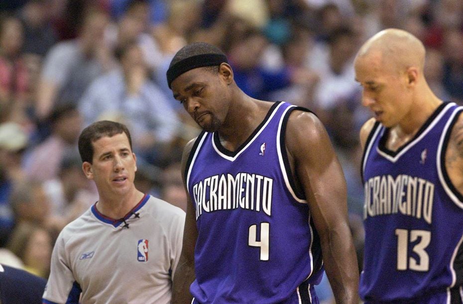 FILE - Chris Webber hangs his head after a second-quarter call, as Tim Donaghy (left) and...