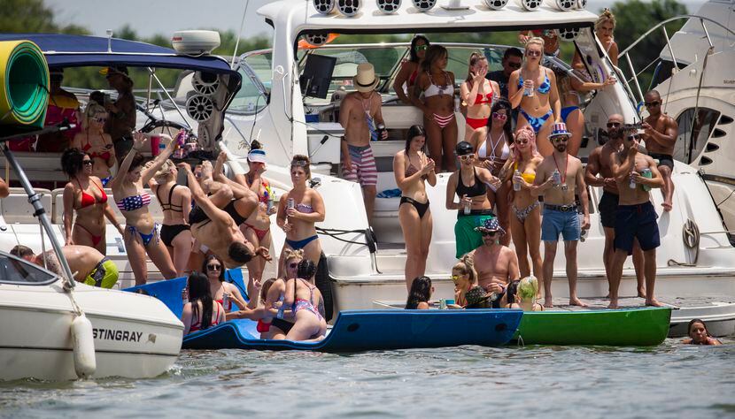 Partiers gathered en masse and without masks for Fourth of July fun under the sun at...
