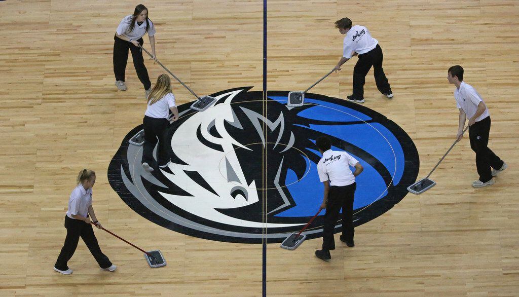 The Mavs logo at half court gets some TLC during a time out during the Orlando Magic vs. the...