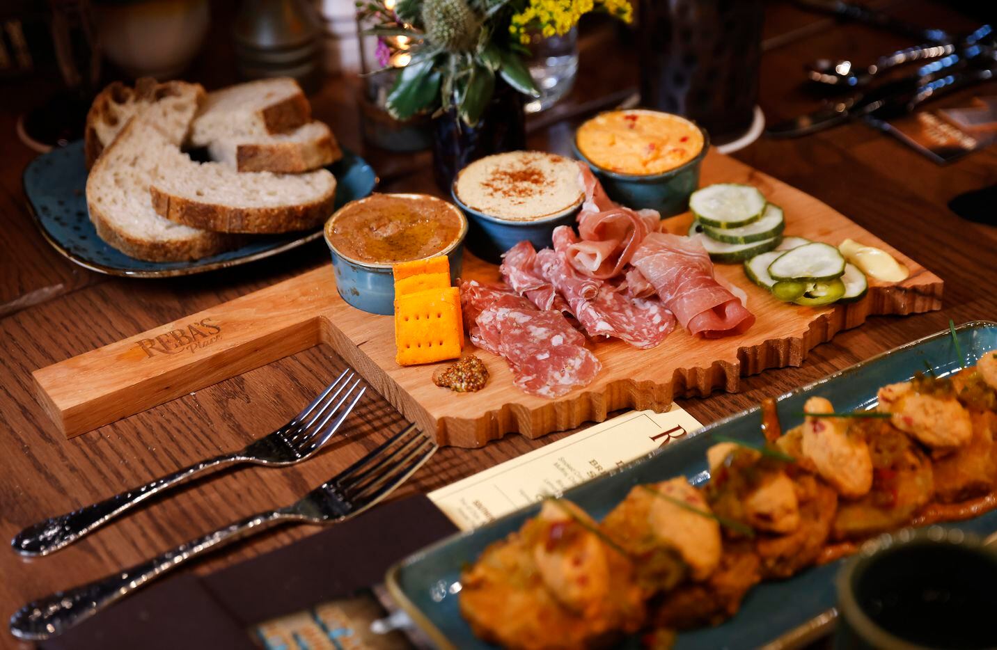 An Oklahoma-shaped charcuterie board full of meats and spreads is served at Reba’s Place in...